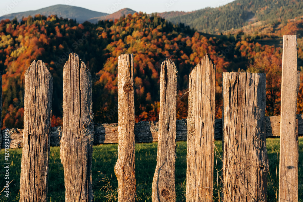 Obraz premium Wooden fence is in the Carpathian mountains, autumn season