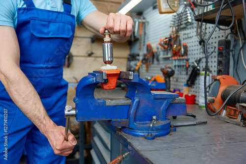 Quadro su tela Cropped shot of craftsman using antique bench vise in repair shop