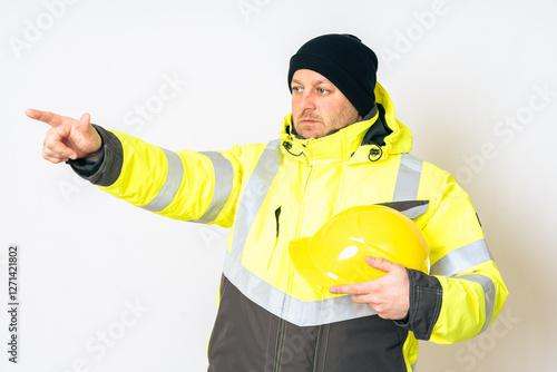 a man wearing a yellow working winter jacket and a yellow safety helmet . High quality photo photo