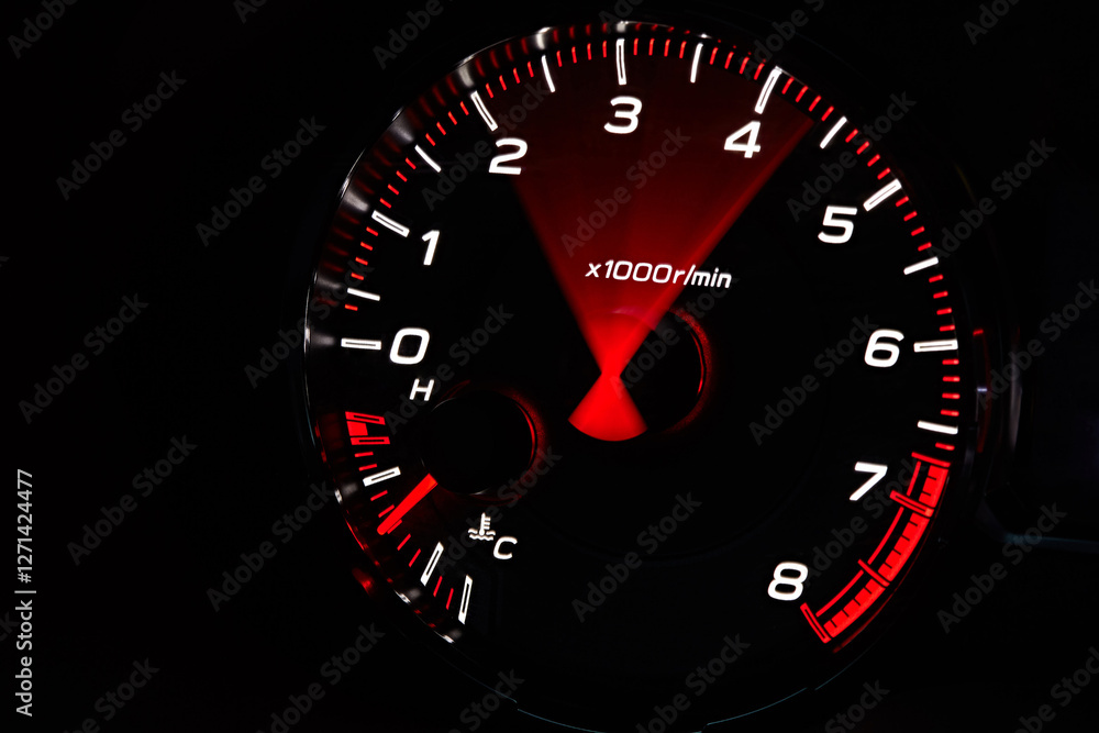 Car dashboard. Red arrow moving on tachometer and engine cooling temperature close-up Car dashboard. Red arrow moving on tachometer and engine cooling temperature close-up