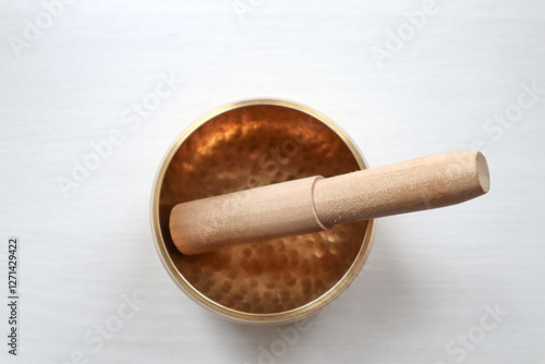 Singing bowl on the table. Soud healing. Tibetan bowl on the white background top view.