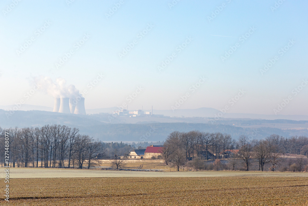 A farmhouse in southern Czechia and the Temelin Nuclear Power Plant on the horizon. Cold winter morning.