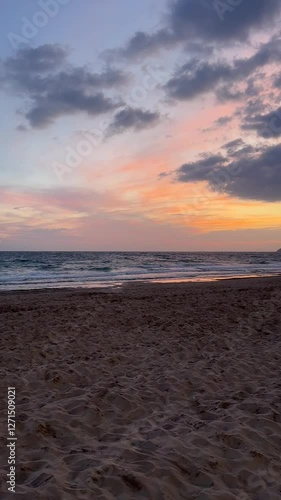 Soft Sunset Over a Tranquil Beach – Gentle Waves and Pastel Sky