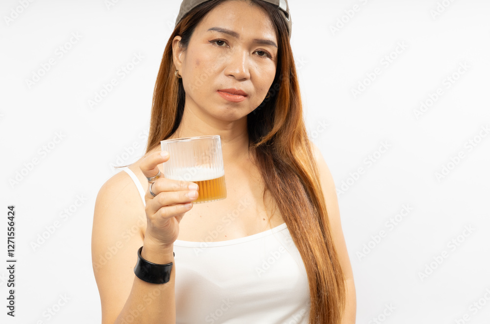 Woman Holds a Glass of Beer While Posing in Casual Attire Against a White Background Woman Holds a Glass of Beer While Posing in Casual Attire Against a White Background