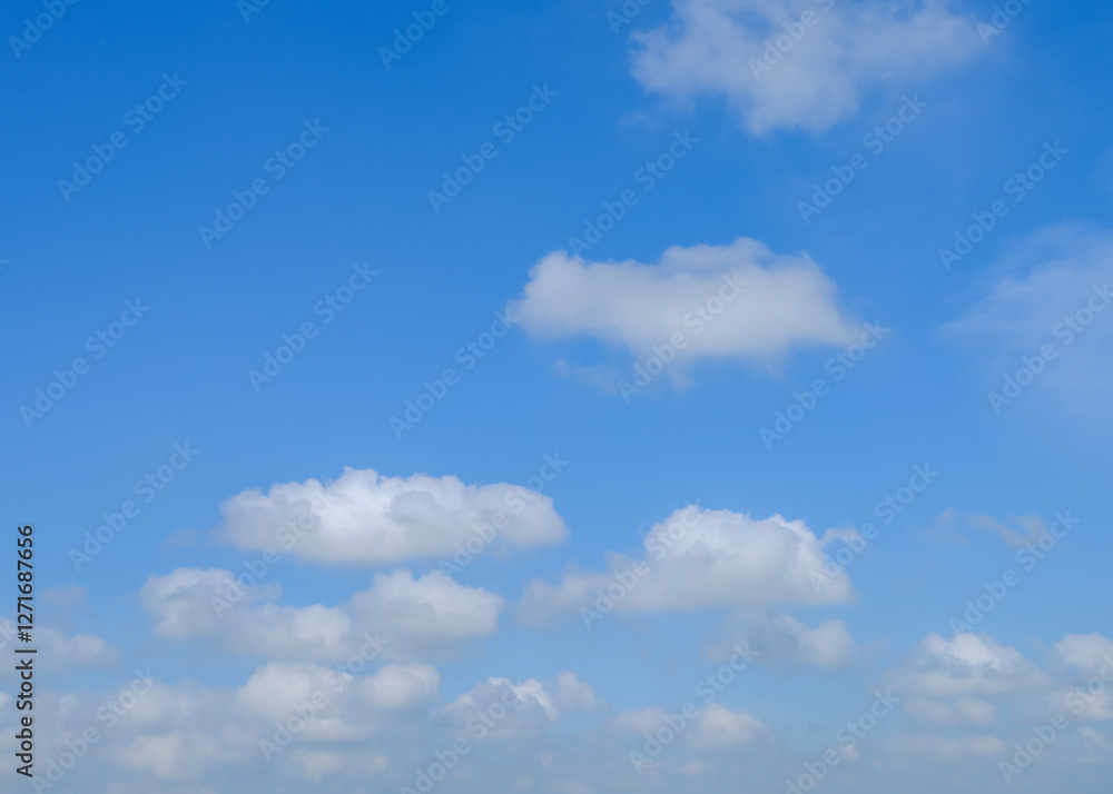 A blue sky background with white cumulus clouds. The clouds are fluffy and bright against the blue sky. A blue sky background with white cumulus clouds. The clouds are fluffy and bright against the blue sky.
