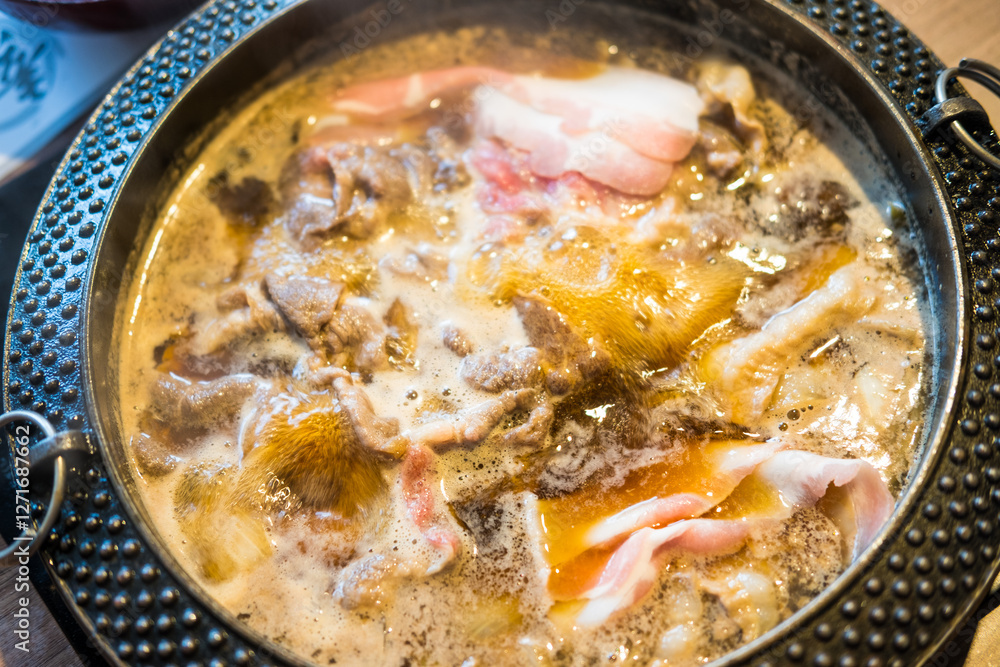 Boiled raw beef in hot sup sukiyaki. Japanese hot pot also known as Shabu Shabu or Sukiyaki is Japanese style.