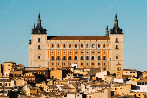 The majestic Alcazar of Toledo stands tall against a clear blue sky, showcasing its architectural grandeur.