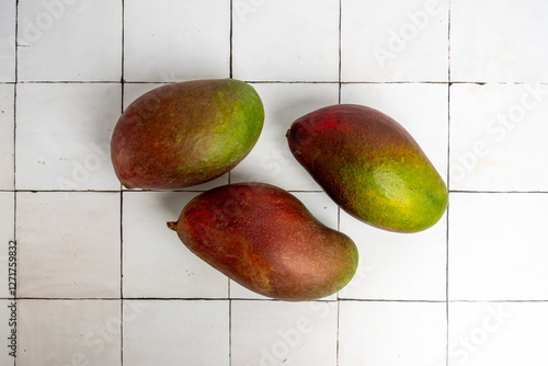 Fresh whole tropical mangos photo