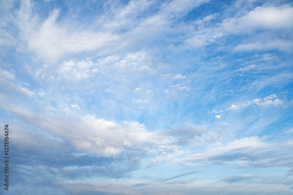 Blue sky adorned with soft wispy white clouds created a peaceful and uplifting atmosphere. A beautiful serene nature background. Nature, wellness, outdoor, mindfulness, environmental awareness. Blue sky adorned with soft wispy white clouds created a peaceful and uplifting atmosphere. A beautiful serene nature background. Nature, wellness, outdoor, mindfulness, environmental awareness.