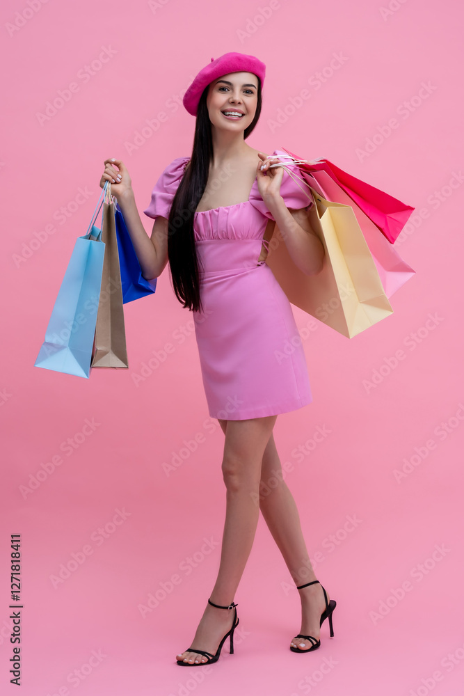 Pretty happy young woman in pink after shopping