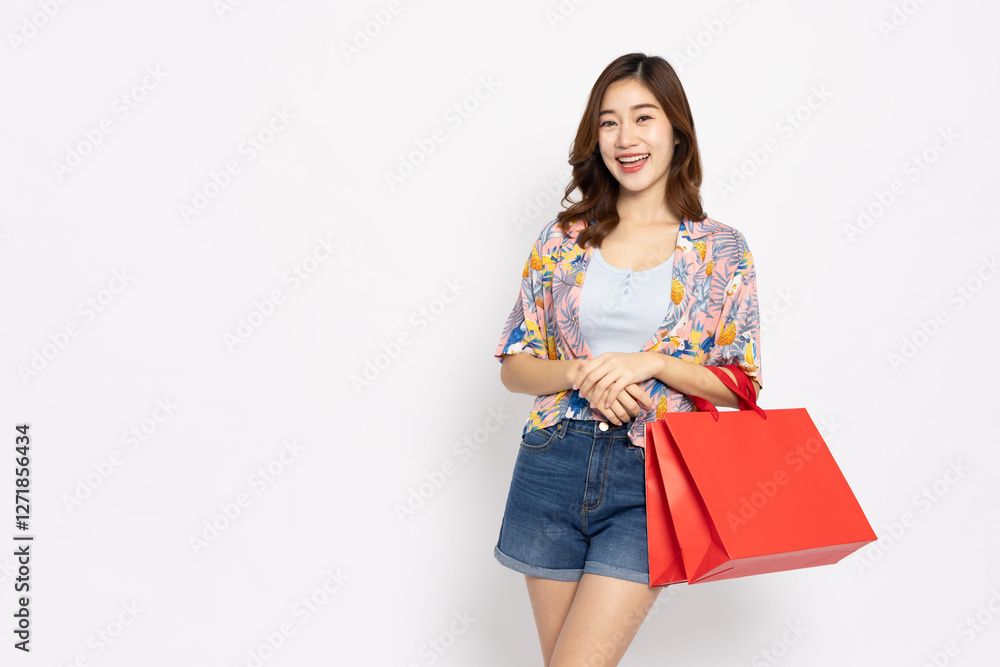 Asian woman traveler holding red shopping bags isolated on white background, Shopper or shopping online in summer season concept Asian woman traveler holding red shopping bags isolated on white background, Shopper or shopping online in summer season concept