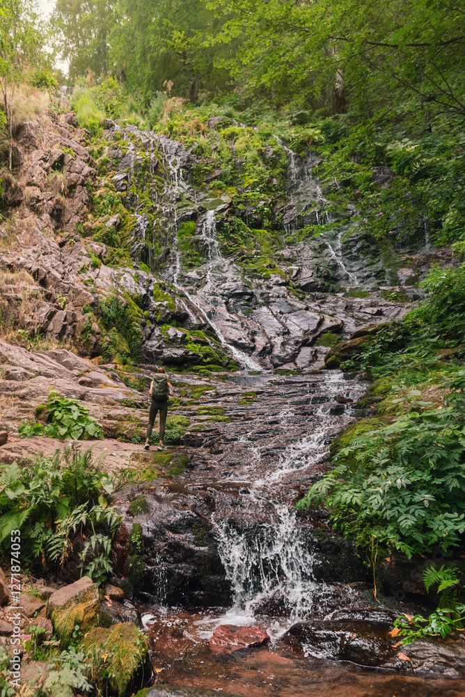 Woman Tourist Enjoying Mountain Waterfall in Forest