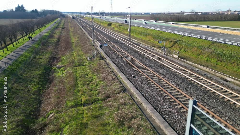 Europe, Italy , Milan - Frecciarossa Hight speed 300km h train railway from Milan to Turin view from the drone - the faster way to travel in Italy for tourist and passengers - tourist destination Europe, Italy , Milan - Frecciarossa Hight speed 300km h train railway from Milan to Turin view from the drone - the faster way to travel in Italy for tourist and passengers - tourist destination