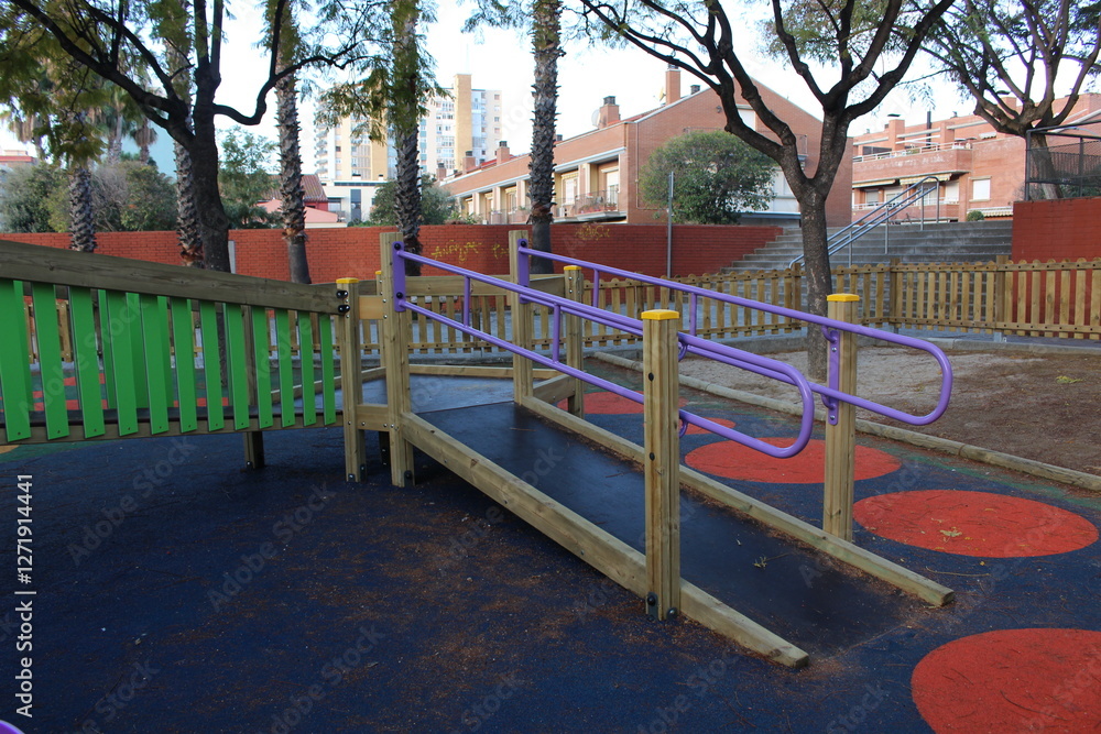 Inclusive playground for children with functional diversity and physical disabilities. Ramp leading up to the play area with bright and fun colours. Rubber flooring with geometric shapes. Inclusive playground for children with functional diversity and physical disabilities. Ramp leading up to the play area with bright and fun colours. Rubber flooring with geometric shapes.