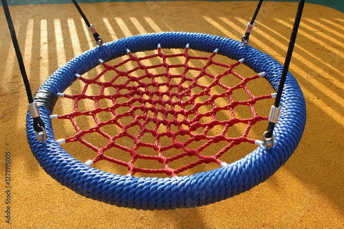 Children's swing adapted for people with physical disabilities. Kids can swing on this park game lying down or stretched out, without having to use any force.