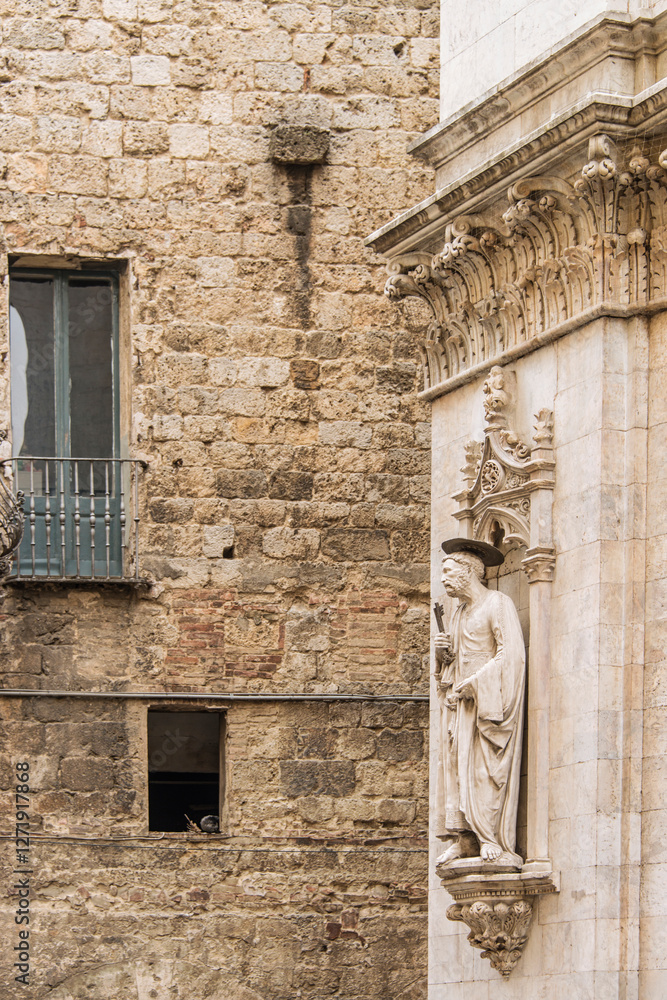 Fototapeta premium Facade of old buildings in the historical center of Siena, the UNESCO World Heritage Centre, unchanged for 13-14 centuries, with its medieval streets looked like in the early Middle Ages. Italy, 2019