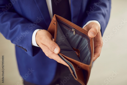 Opening empty wallet, poor person having no money in purse, bankrupt with financial problems. Low income, lacking budget, hardship, job loss, lack of planning, debt management, disadvantaged, needy photo