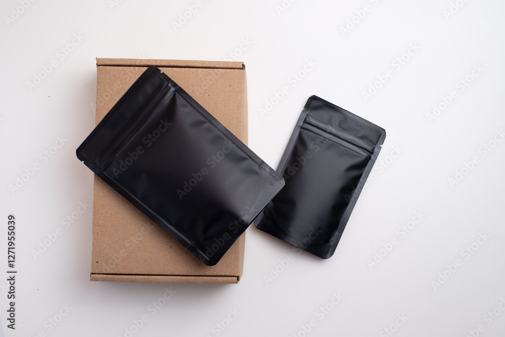 Black packages for tea, coffee, snacks and cosmetics in the background. Branding and packaging mockup for products. Packing closeup. Product for sale. Empty, mockup Black packages for tea, coffee, snacks and cosmetics in the background. Branding and packaging mockup for products. Packing closeup. Product for sale. Empty, mockup