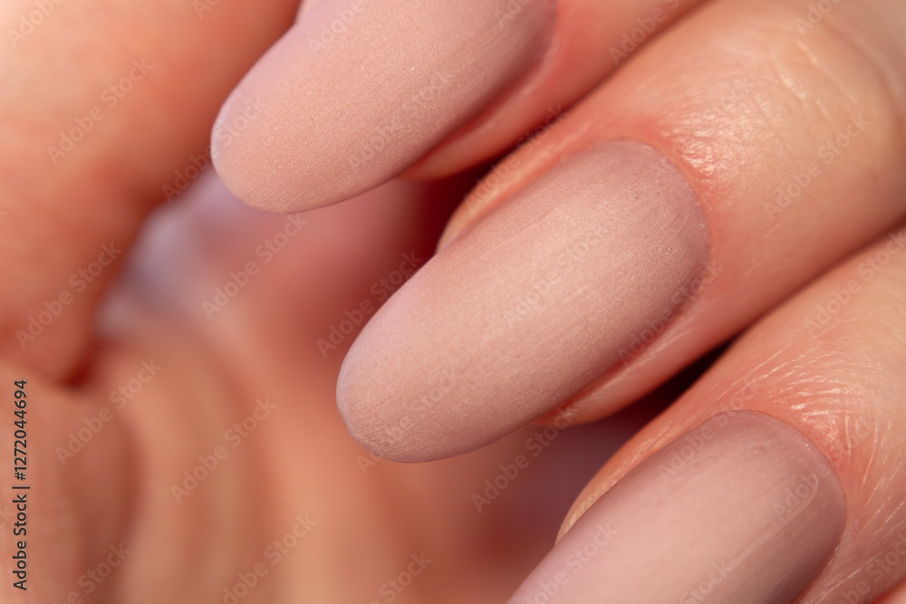 Macro shot of a matte nude manicure on oval-shaped extended nails – the soft, velvety texture of the finish enhances the delicate shade. The soft, velvety finish highlights the delicate shade. Macro shot of a matte nude manicure on oval-shaped extended nails – the soft, velvety texture of the finish enhances the delicate shade. The soft, velvety finish highlights the delicate shade.