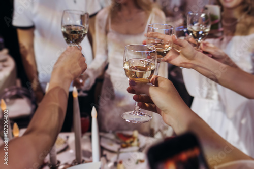 Wallpaper Mural Group of guests celebrate and raise glasses, toasting and cheering with alcohol glasses with wine and champagne in a restaurant on corporate christmas, birthday party prom event or wedding celebration Torontodigital.ca