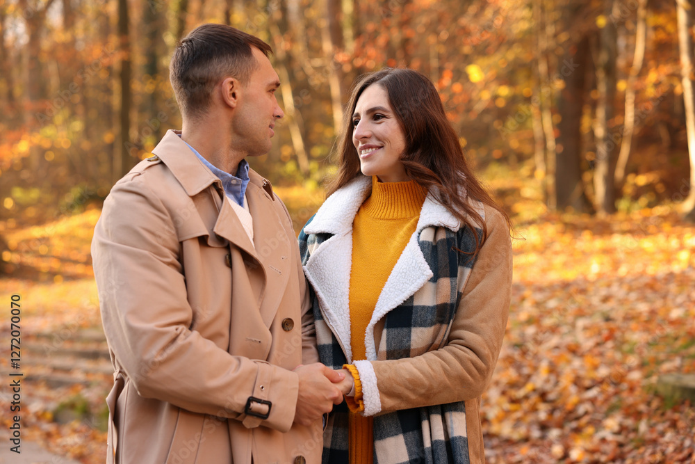 Happy couple spending time together in autumn park