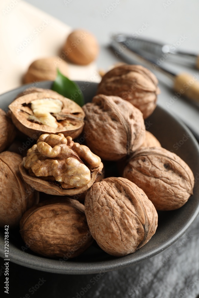 Fresh walnuts in bowl on table, closeup Fresh walnuts in bowl on table, closeup
