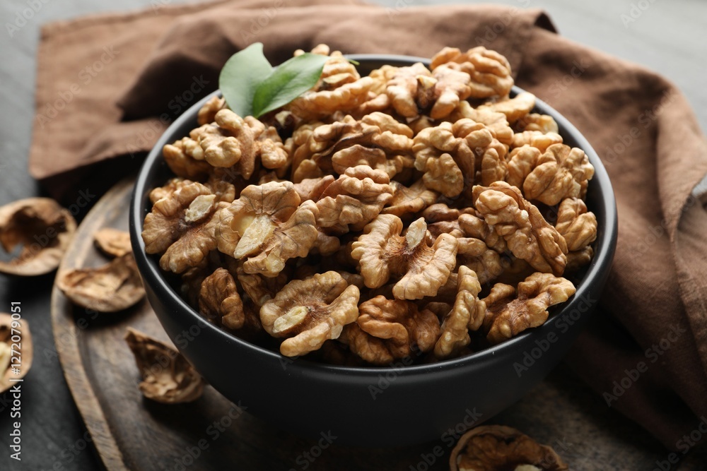 Fresh ripe walnuts in bowl on table, closeup Fresh ripe walnuts in bowl on table, closeup