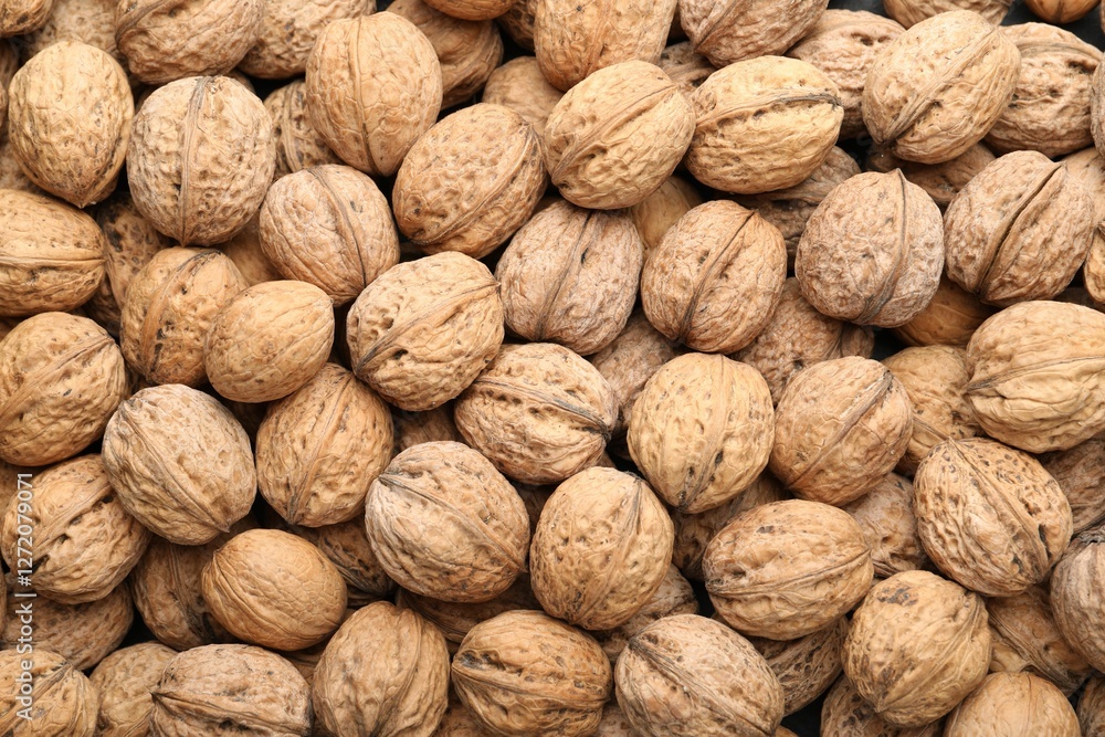Fresh walnuts in shells as background, top view Fresh walnuts in shells as background, top view