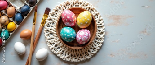 Easter Egg Decorating Concept: White Eggs , Painted Eggsin Wooden Holder, on a lace knitted napkin, Brush, and Paints. Top view, copy space photo