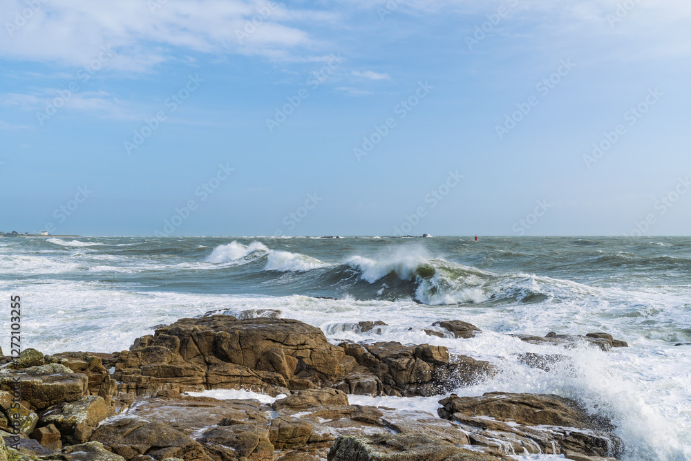 Vagues déchaînées s’écrasant sur les rochers de Lesconil sous un ciel bleu moucheté de nuages d’hiver. Vagues déchaînées s’écrasant sur les rochers de Lesconil sous un ciel bleu moucheté de nuages d’hiver.