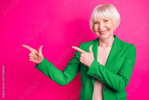 Portrait of her she nice-looking attractive lovely representative elegant classy cheerful glad gray-haired lady pointing aside ad isolated over bright vivid shine vibrant pink fuchsia color background