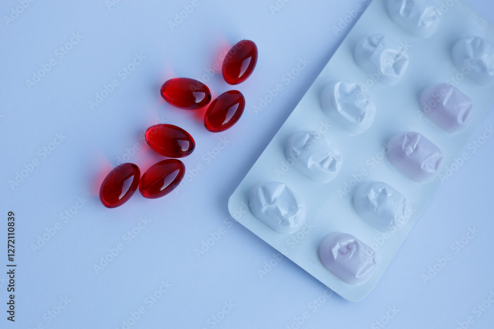 red capsules and capsule plate on white background red capsules and capsule plate on white background