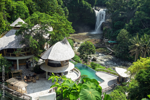 Waterfall landscape. Tegenungan waterfall in jungle Ubud, Bali island Indonesia. Wallpaper background. Natural scenery. Photo of the summer cafe. Touristic resort.