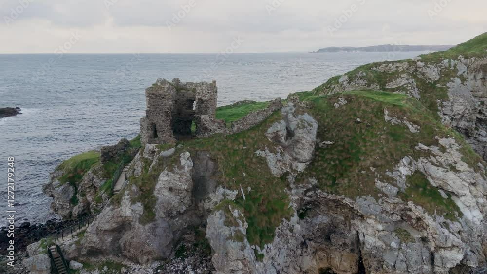 Kinbane Castle in Northern Ireland - A stunning and breathtaking view of a wild, rugged shore showcasing ancient ruins alongside beautiful ocean waves Kinbane Castle in Northern Ireland - A stunning and breathtaking view of a wild, rugged shore showcasing ancient ruins alongside beautiful ocean waves