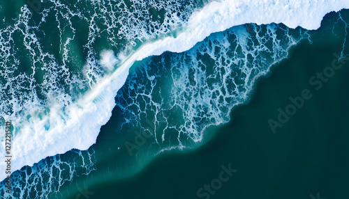 Aerial view of ocean waves crashing onto a sandy beach, symbolizing natural beauty, tranquility, and the power of nature for themes around travel, coastal landscapes, and relaxation photo