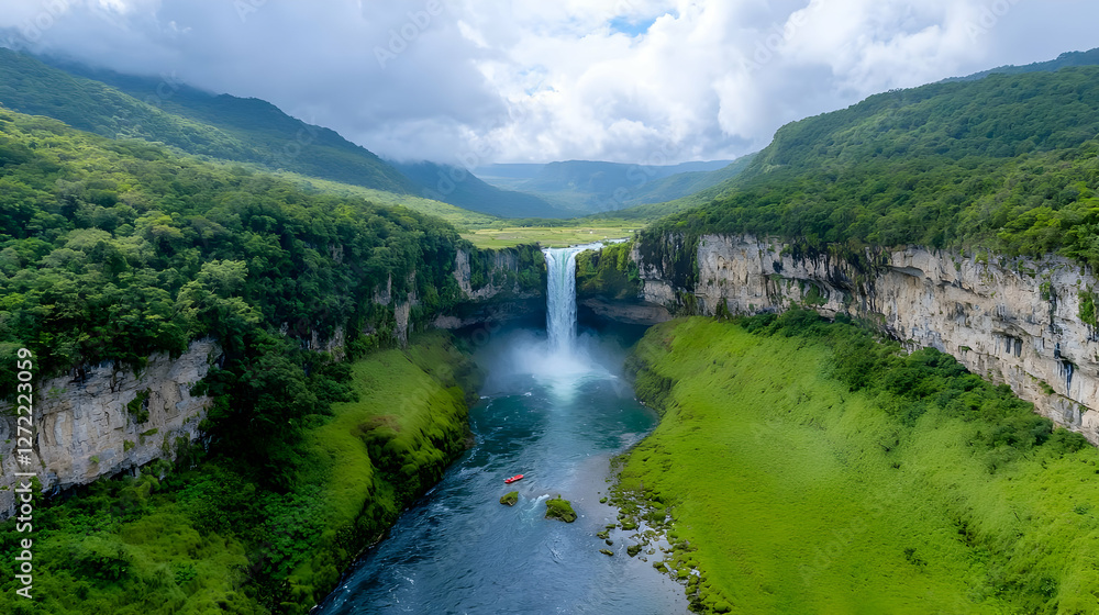 Fototapeta premium Aerial view of a majestic waterfall cascading into a lush green valley