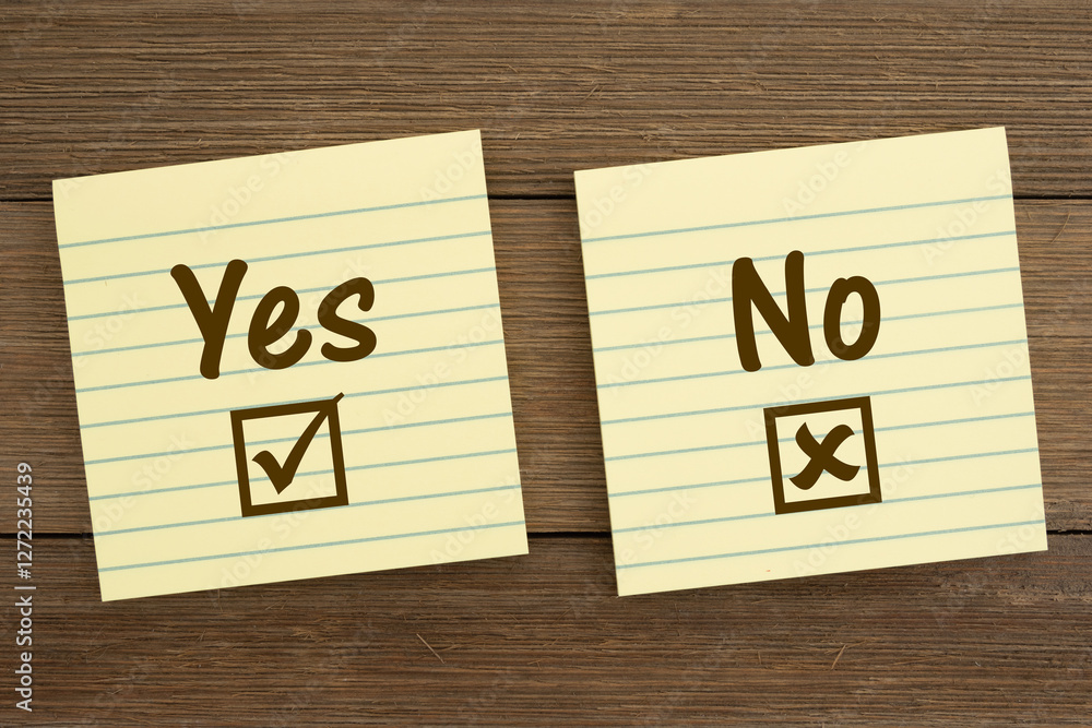 Yes and no choice on yellow lined sticky notes on wood Yes and no choice on yellow lined sticky notes on wood