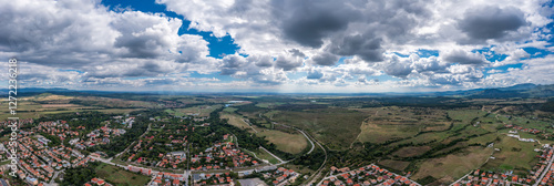 Obraz na płótnie Panoramic aerial view of a mountain town under rolling hills w salonie