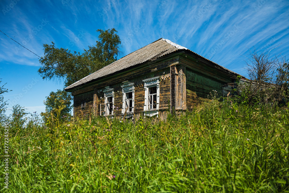 Abandoned wooden house with broken windows in rural area Abandoned wooden house with broken windows in rural area