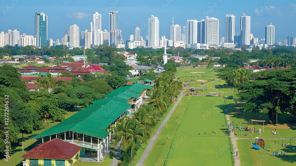 Naklejka premium Tropical city skyline golf course aerial view, lush green fairways, clubhouse, recreation