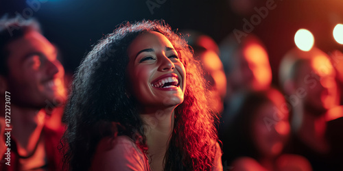 Wallpaper Mural People laughing and enjoying a comedy show in a crowded theater, surrounded by smiling audience members. Torontodigital.ca