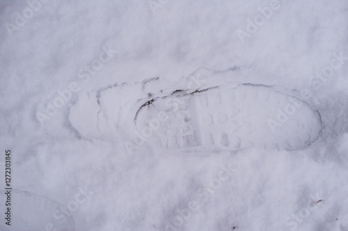 footprints in the snow from men's shoes