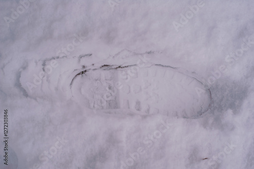 footprints in the snow from men's shoes