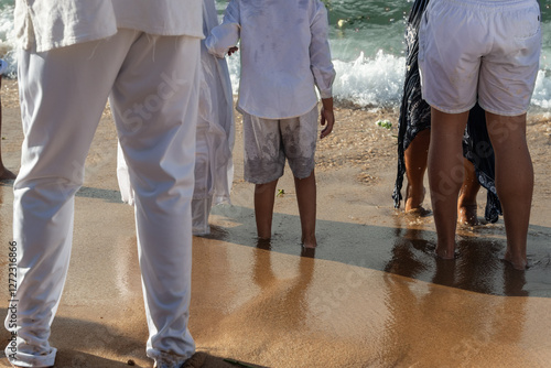 Religious people and tourists are seen participating in the Iemanja festival on Rio Vermelho beach. City of Salvador, Bahia. photo