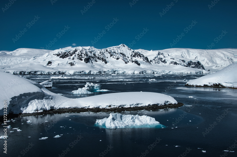 Fototapeta premium Antarctic Peninsula iceberg, snow-capped mountains.