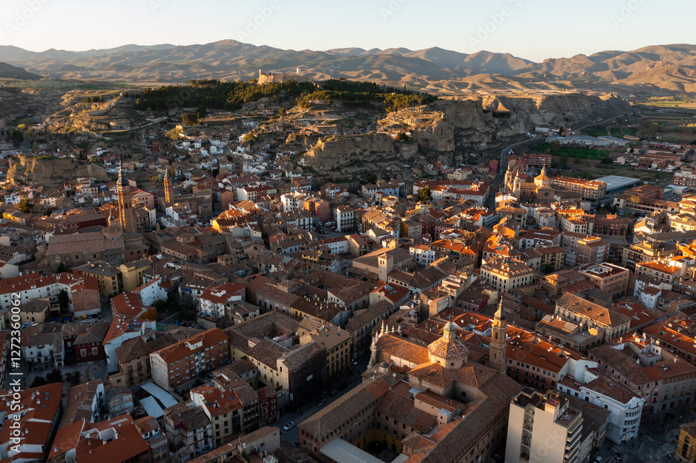 Fototapeta premium Aerial view of Spanish town of Calatayud located on scenic landscape of Sistema Iberico mountain range on sunny spring day, Province of Zaragoza
