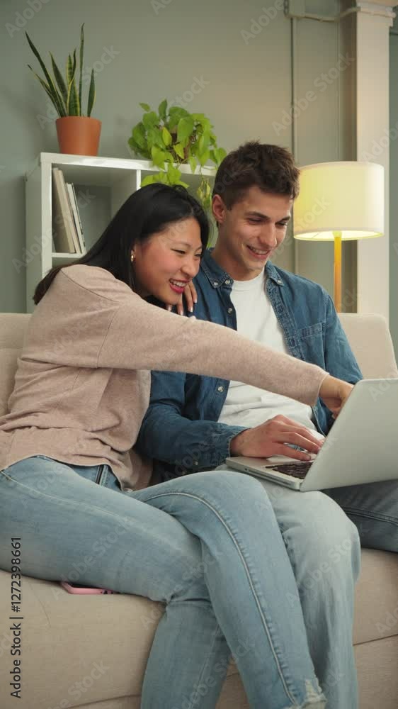A Joyful Couple Engaged in Watching and Searching for Exciting Travel Options Together on Their Laptop. They are Clearly Happy and Smiling While Enjoying Each Other's Company in Their Comfortable Home A Joyful Couple Engaged in Watching and Searching for Exciting Travel Options Together on Their Laptop. They are Clearly Happy and Smiling While Enjoying Each Other's Company in Their Comfortable Home