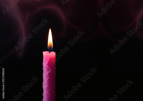 A captivating pink candle flame glowing against a dark black background, perfect for romantic, mystical, or elegant themes. Ideal for copyspace and creative projects. photo