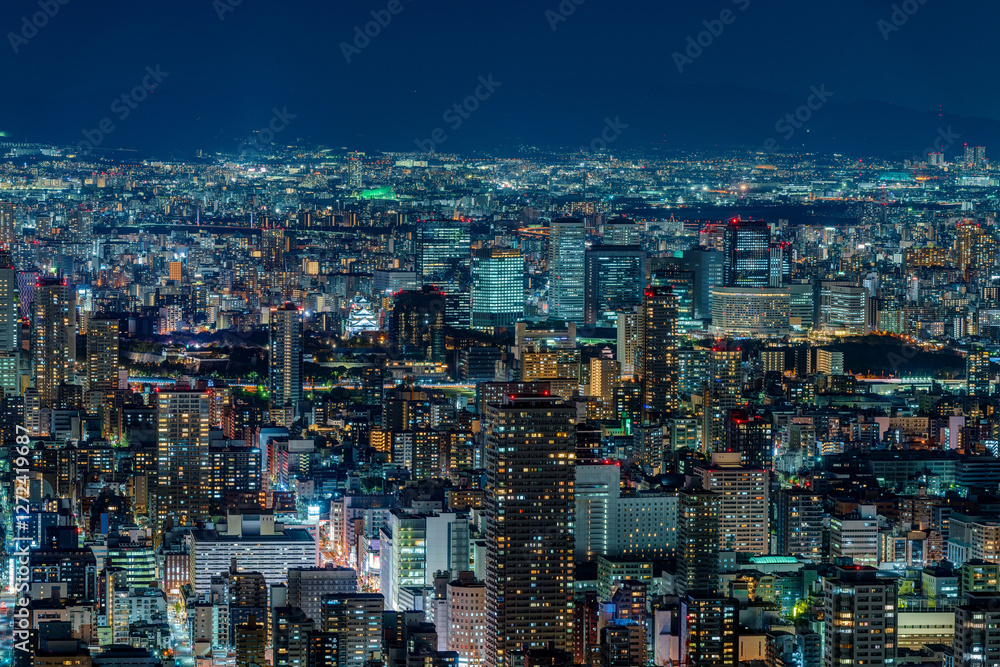 Dense buildings with Osaka castle at Osaka central area at night
