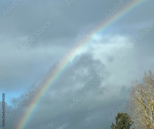 blue sky with clouds and rainbow